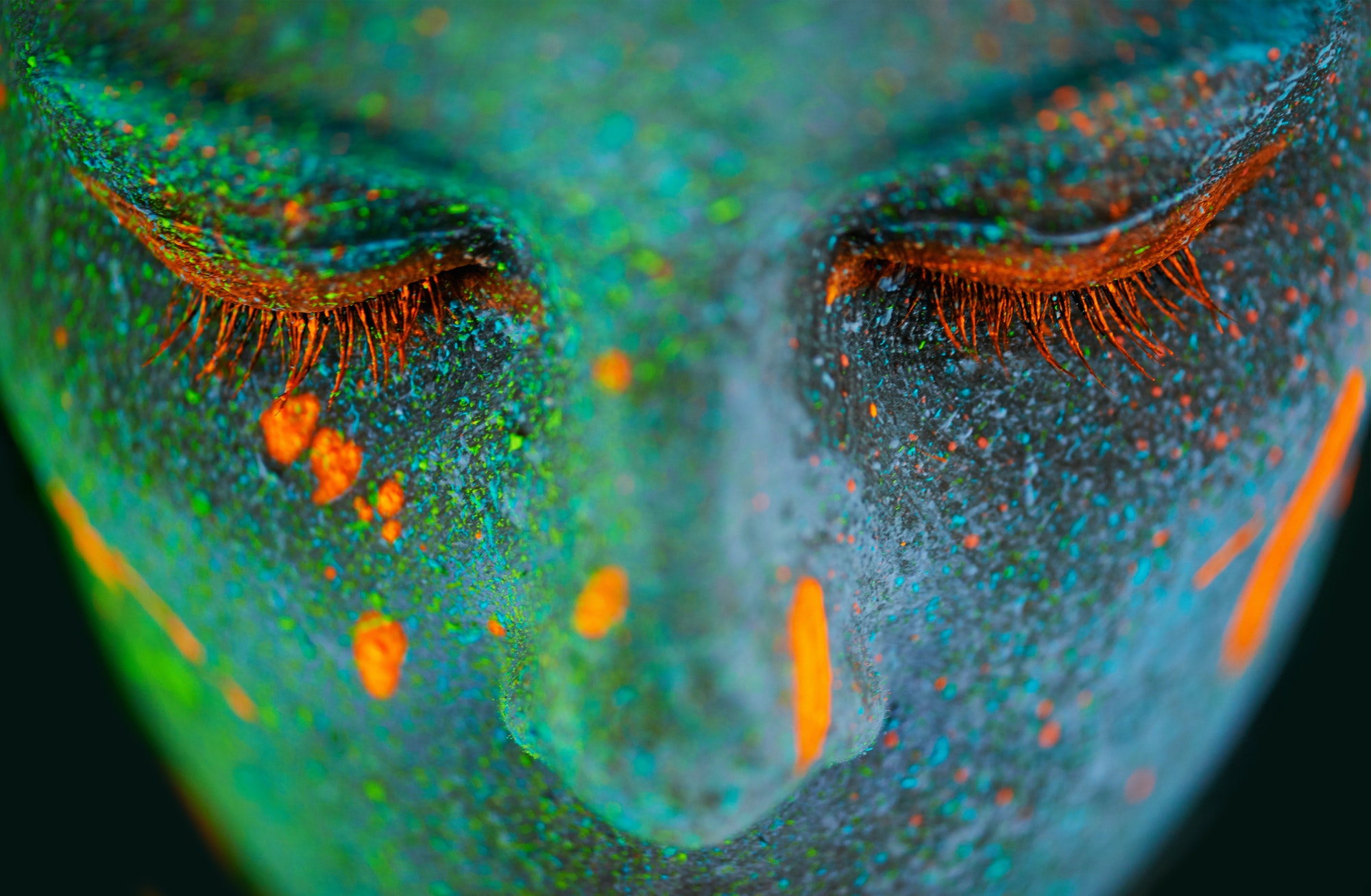 Her beauty glows in the dark. Shot of a young woman posing with neon paint on her face.